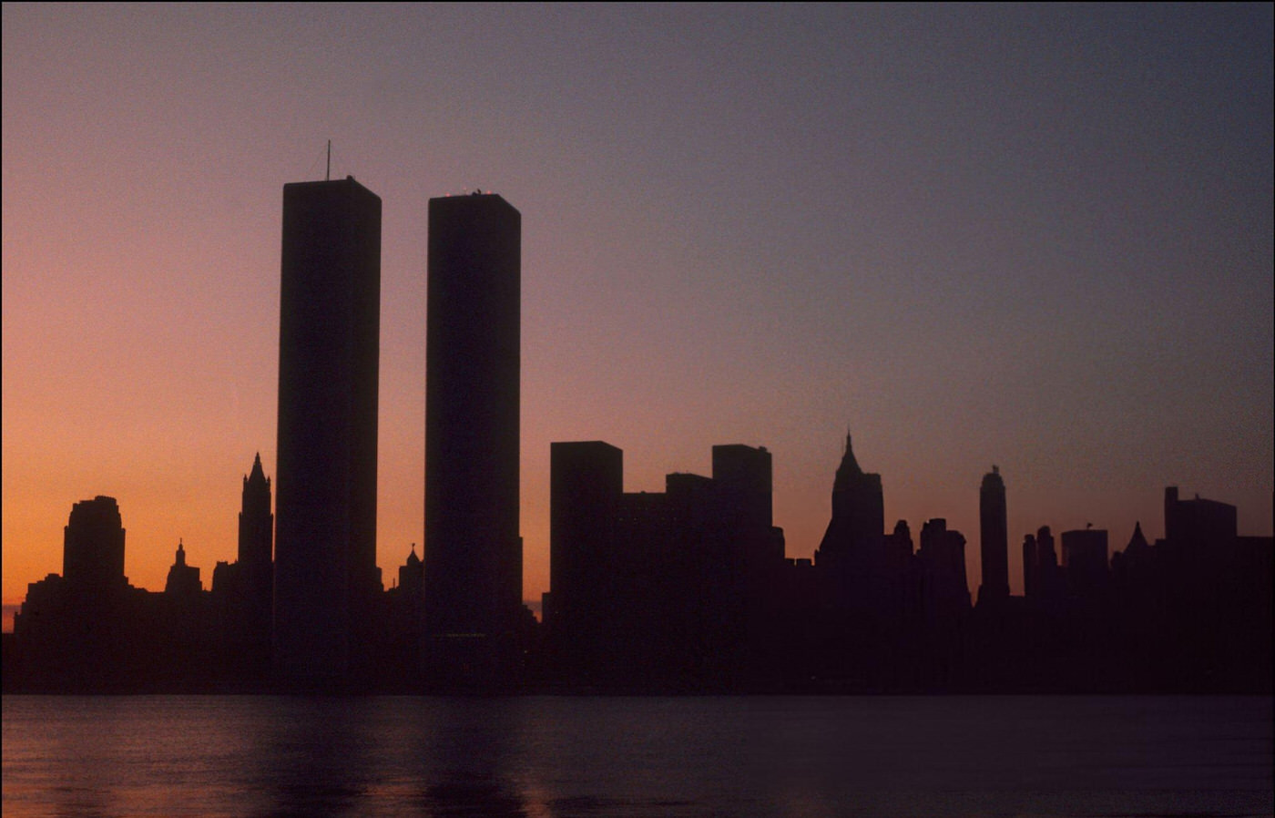 The twin towers of the World Trade Center on the first morning of the power blackout, as seen from Jersey City, New Jersey, 1977.