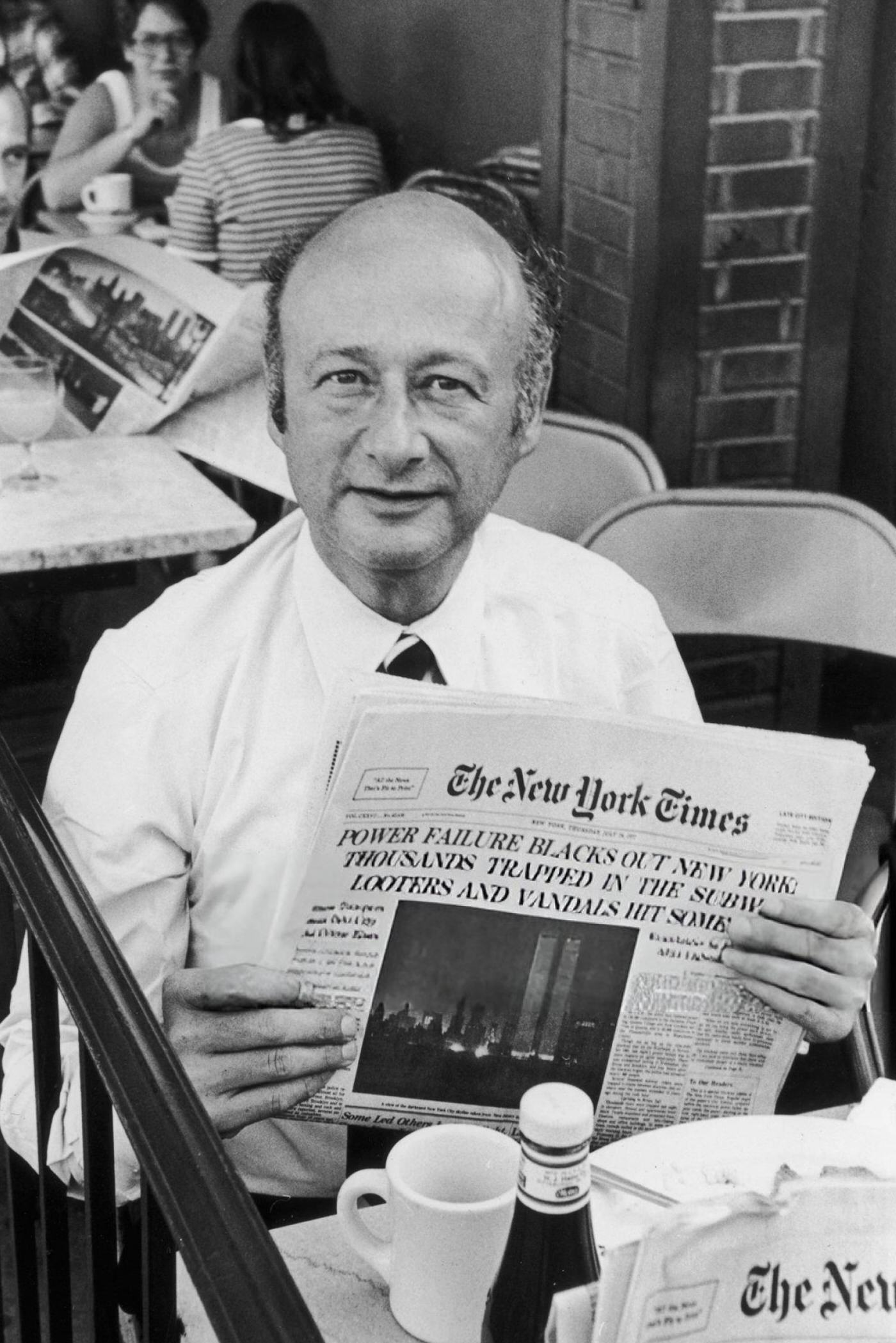 American politician and soon-to-be mayor of New York City Ed Koch reads about the power blackout, 1977.