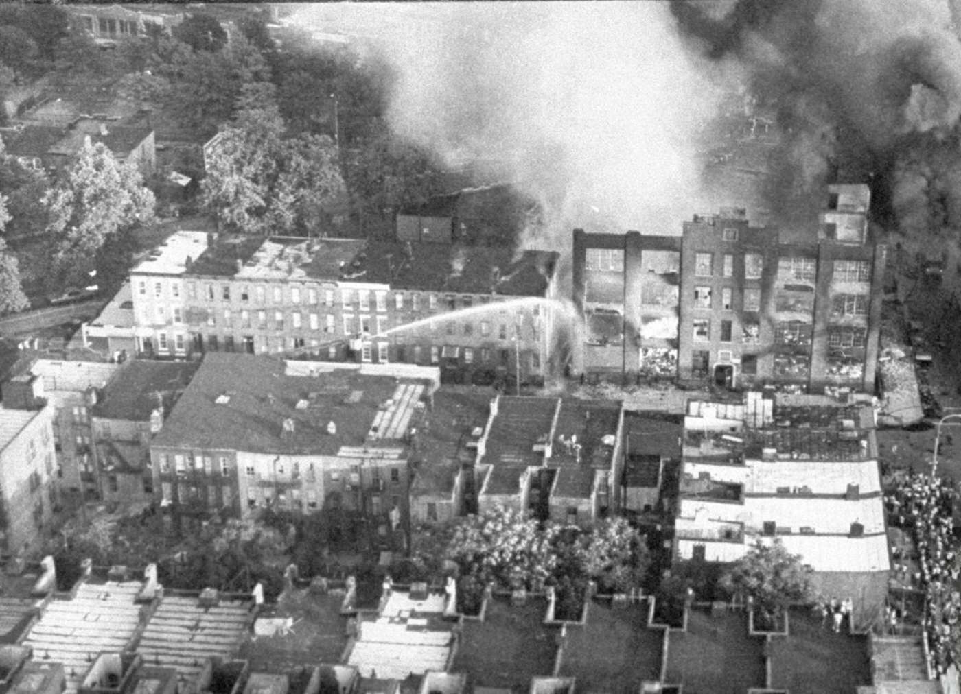 Crowds gather to watch fires that followed looting at Stone Street and Summers Avenue, Brooklyn, during the blackout, 1977.