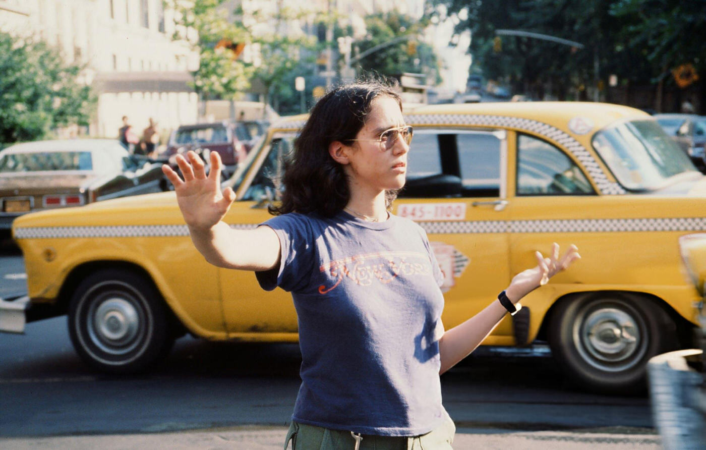 A young woman directs traffic in the wake of the New York City blackout, Brooklyn, 1977.