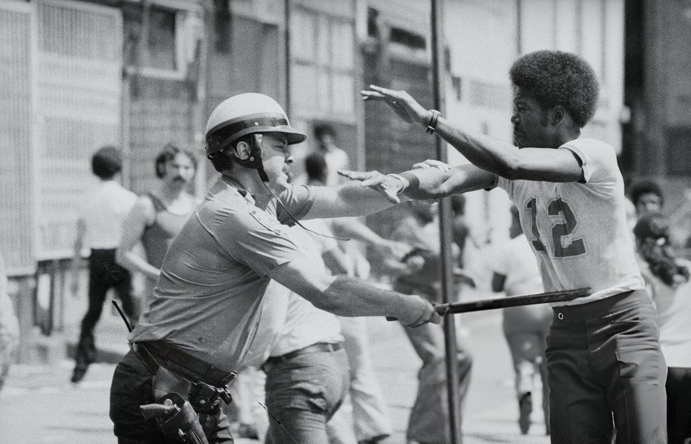A policeman collars a looter in the Bushwick section of Brooklyn during the blackout, 1977.