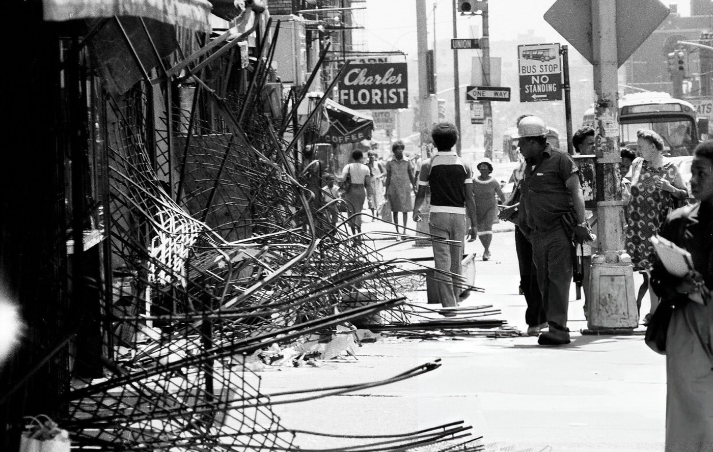Storefront gates failed to keep out looters at Utica and Union St. and Eastern Parkway in Brooklyn after the blackout, 1977.