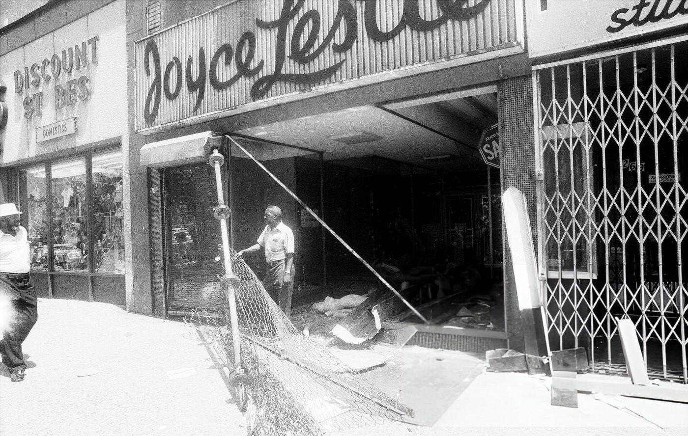 Storefront gates failed to keep out looters at this Joyce Leslie clothing store after the blackout, 1977.