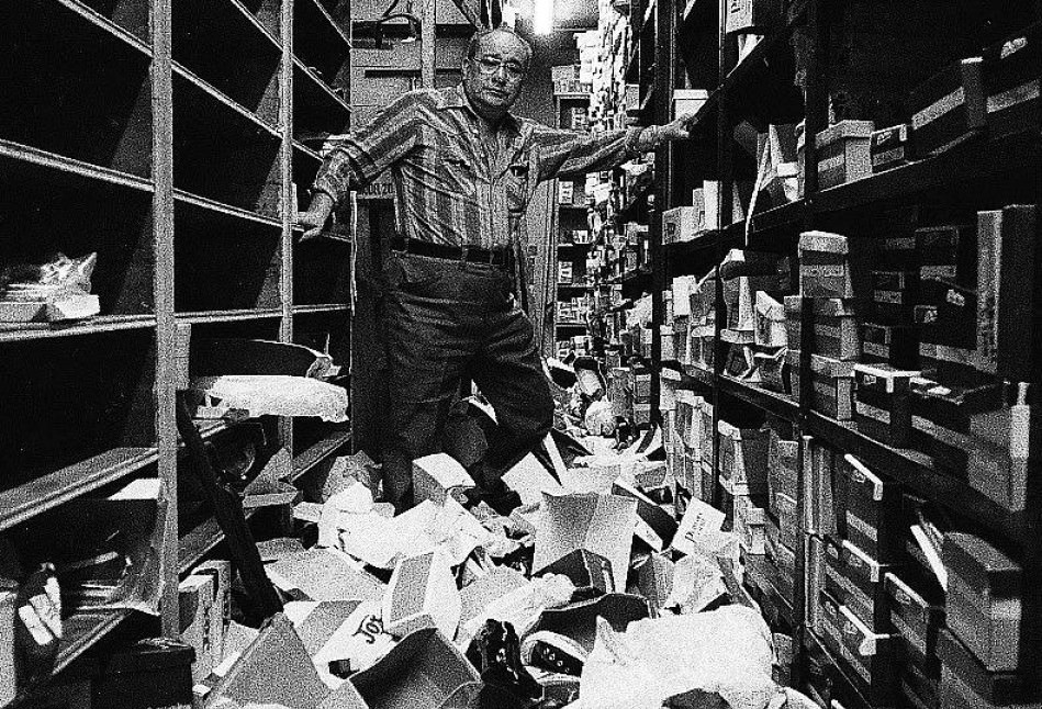 Solomon Altheim looks over the wreckage at his shoe store after it was looted during the blackout, 1977.