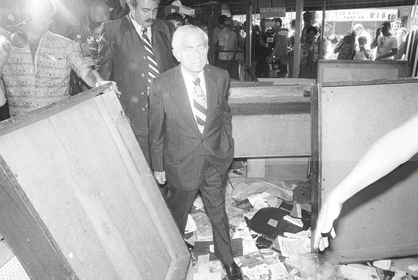 Mayor Abe Beame visits merchants after looting during the blackout at Broadway, near Greene Avenue in Brooklyn, 1977.