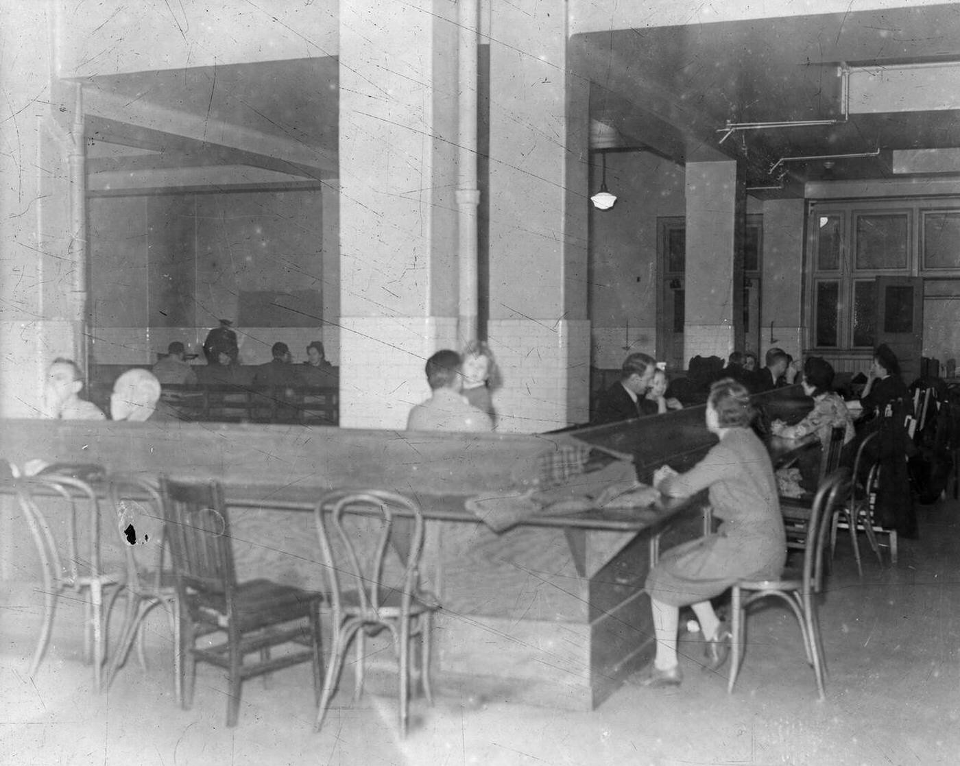 Detained 'enemy aliens' receiving visitors while interned on Ellis Island during World War II, 1943.