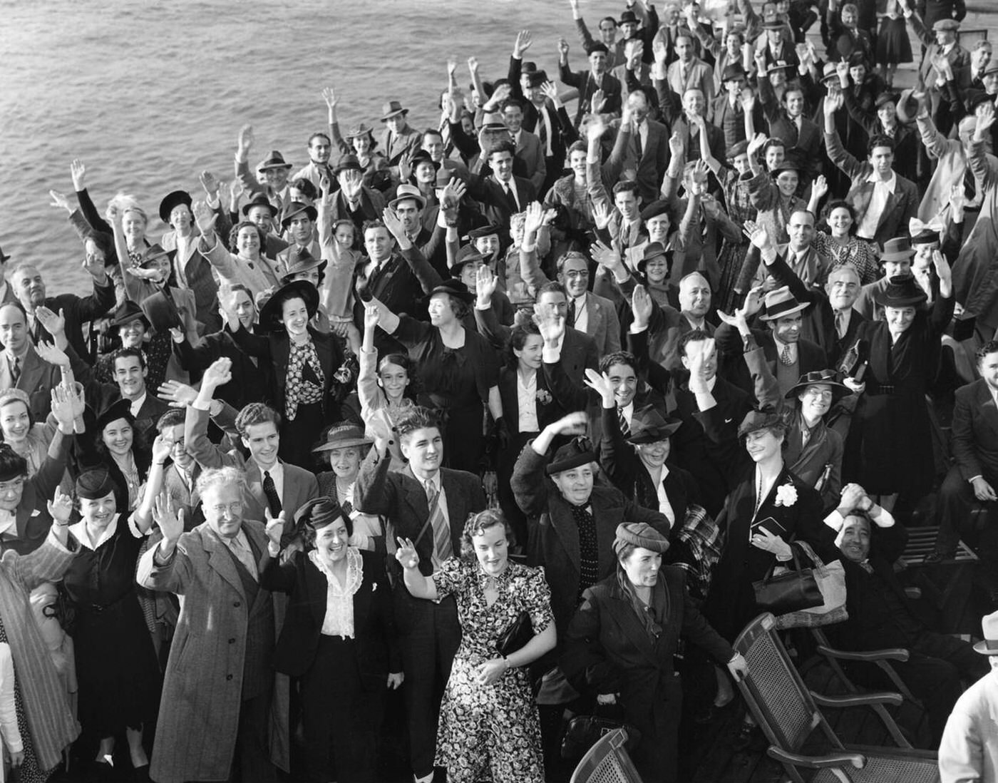 American passengers cheer on the deck of the "Ile de France" on their return from Europe, 1939.