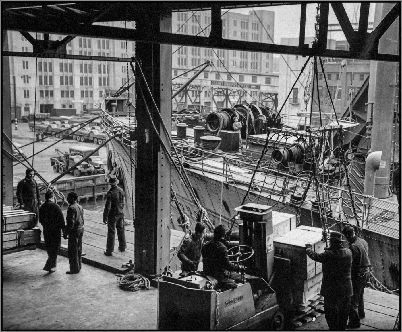 Ships loading for convoy at the port of embarkation at Brooklyn Navy Yard, New York, 1940s.