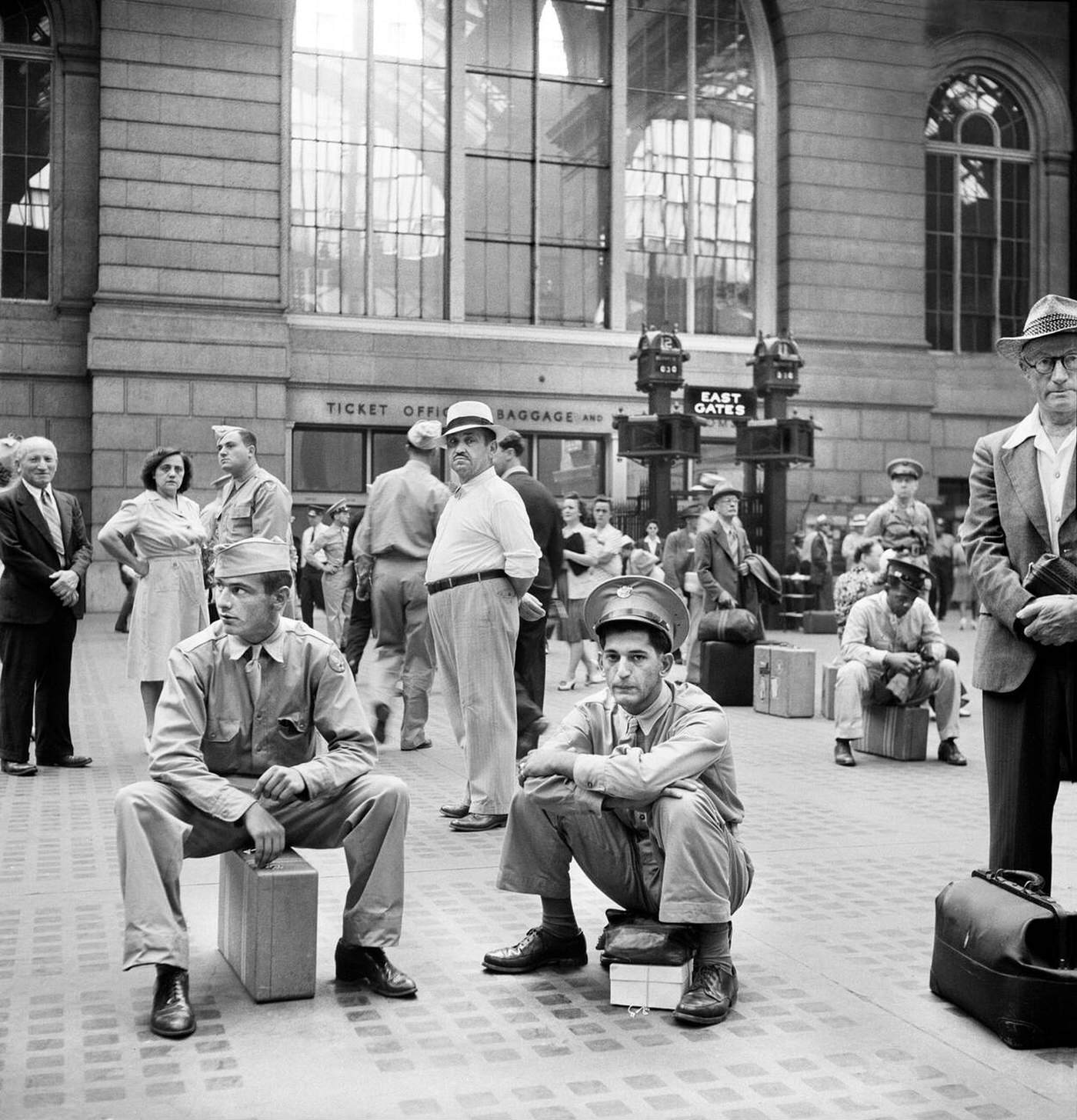 Civilians and military service men waiting for trains, Pennsylvania Station, New York City, 1942.