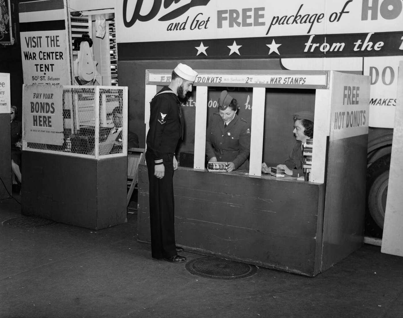 Sailor buying war stamps at donut mobile at Bowling Green, New York City, 1943.