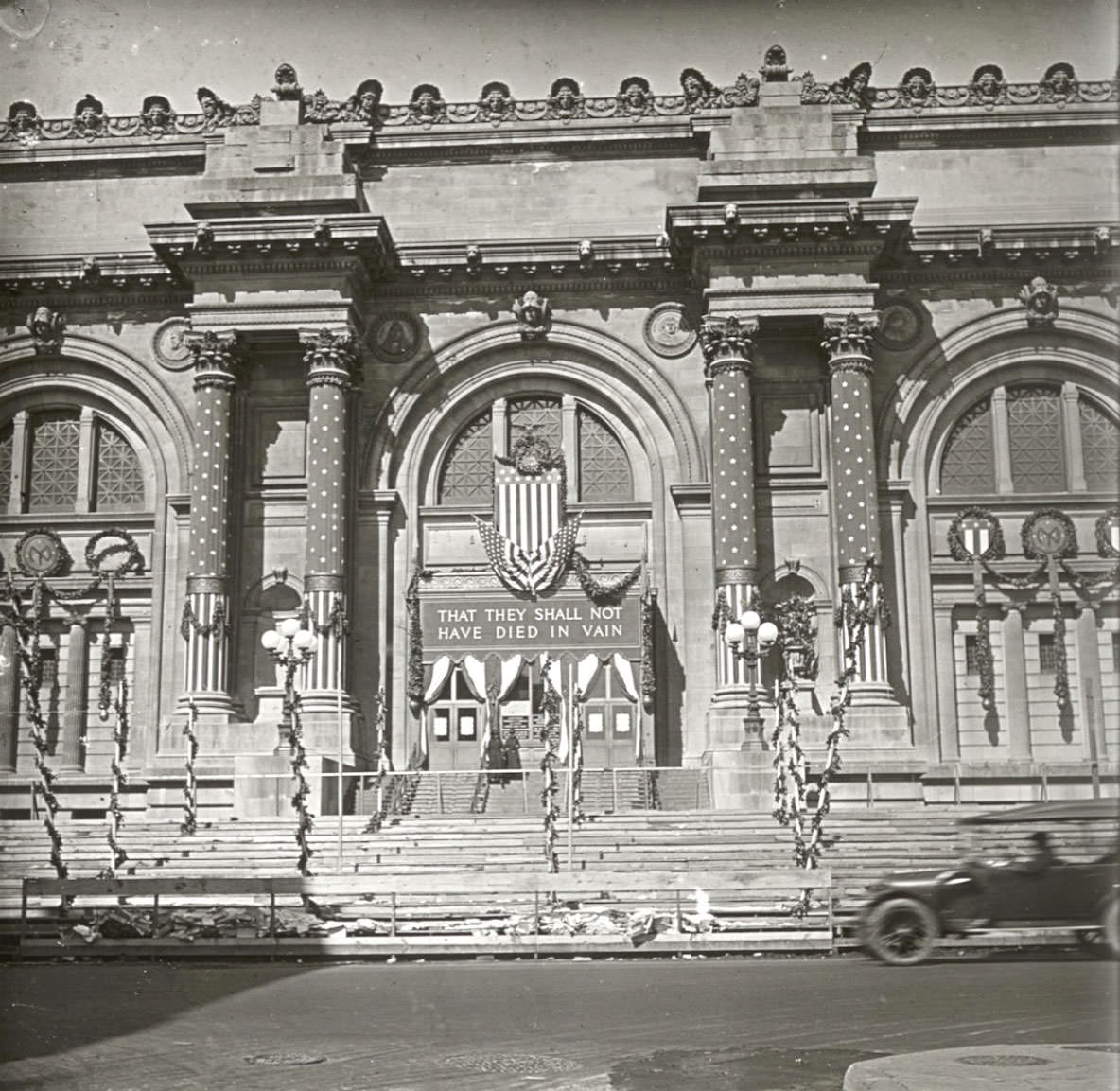 Columns wrapped and a banner above the doorway reads: “THAT THEY SHALL NOT HAVE DIED IN VAIN."