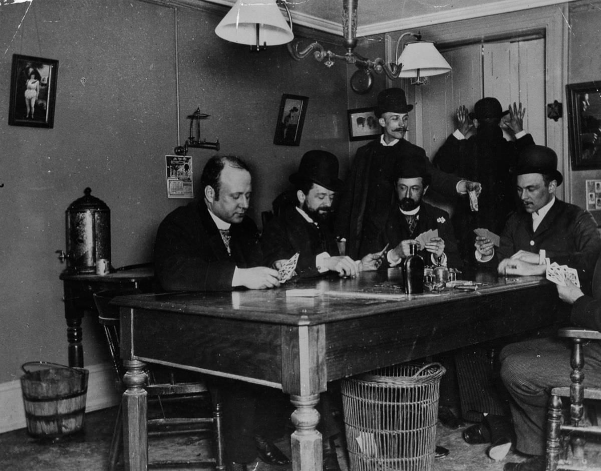 Men play cards in a New York building, 1890.