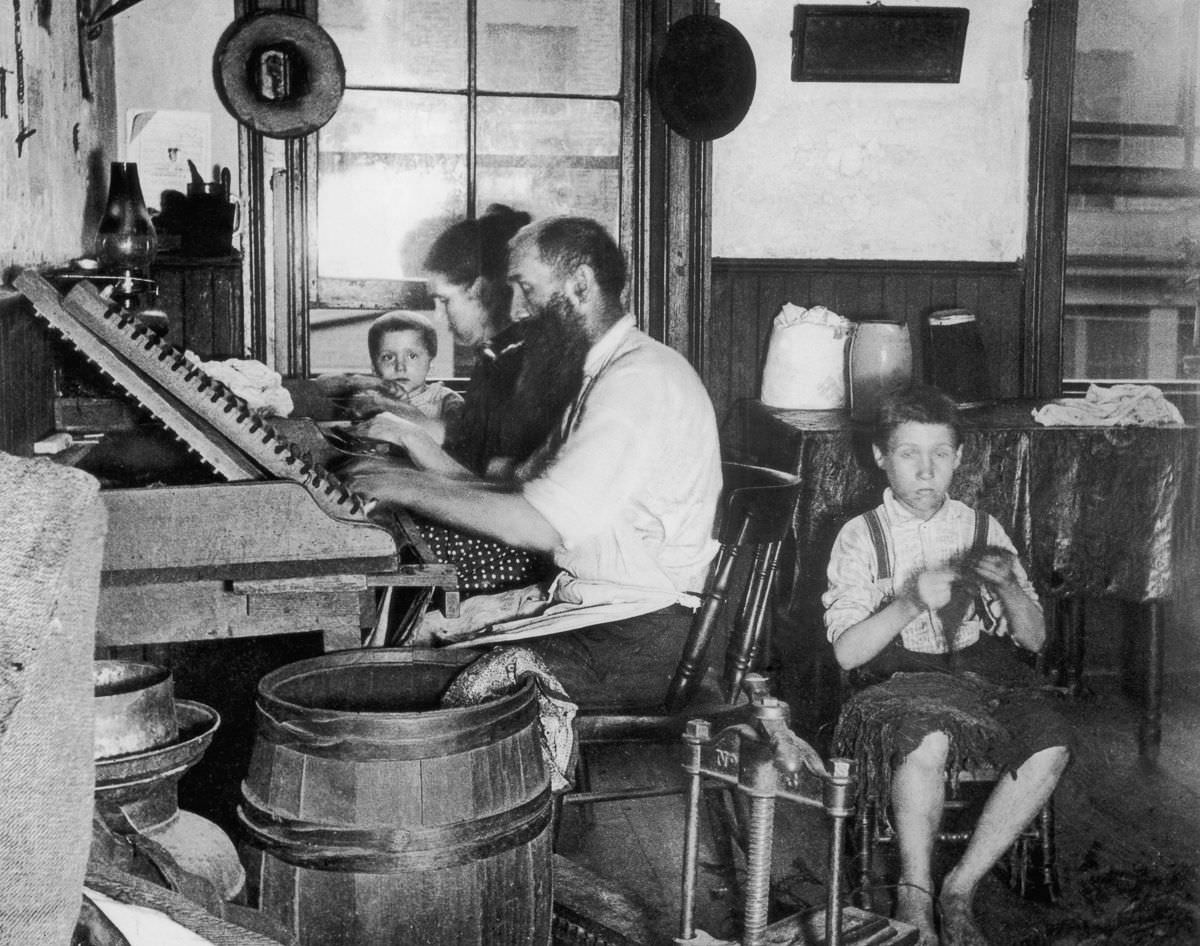 A Bohemian family makes cigars at home in their tenement, 1890.