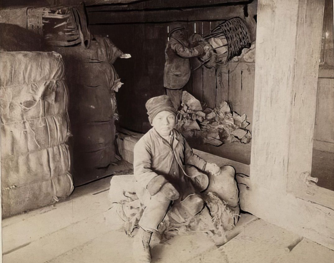 A child living near a dump, 1900.