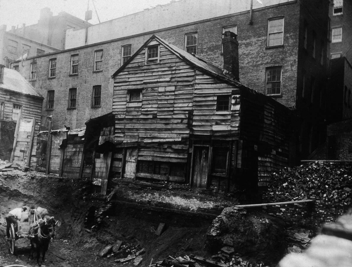 A backlot house on Bleecker Street between Mercer and Greene Streets, adjacent to an excavation site, 1890.
