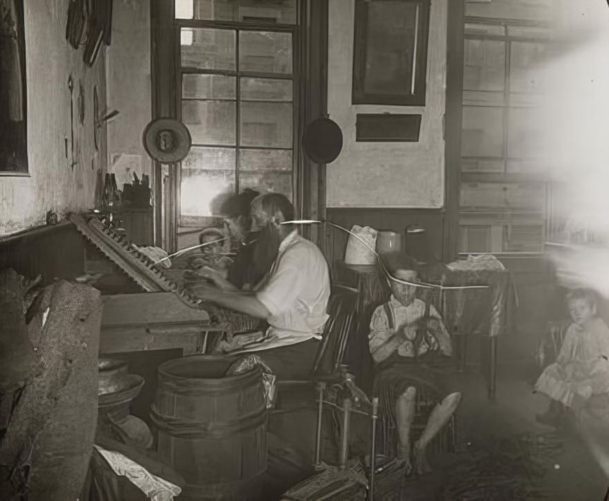Bohemian cigar makers at work in their tenement, 1890.