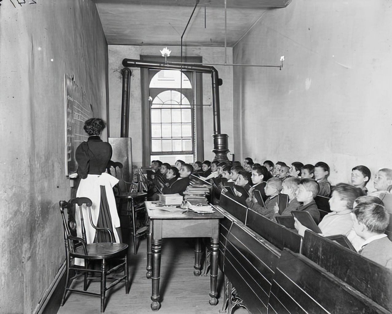 East Side Public Schools: A class in the condemned Essex Market School, 1890.