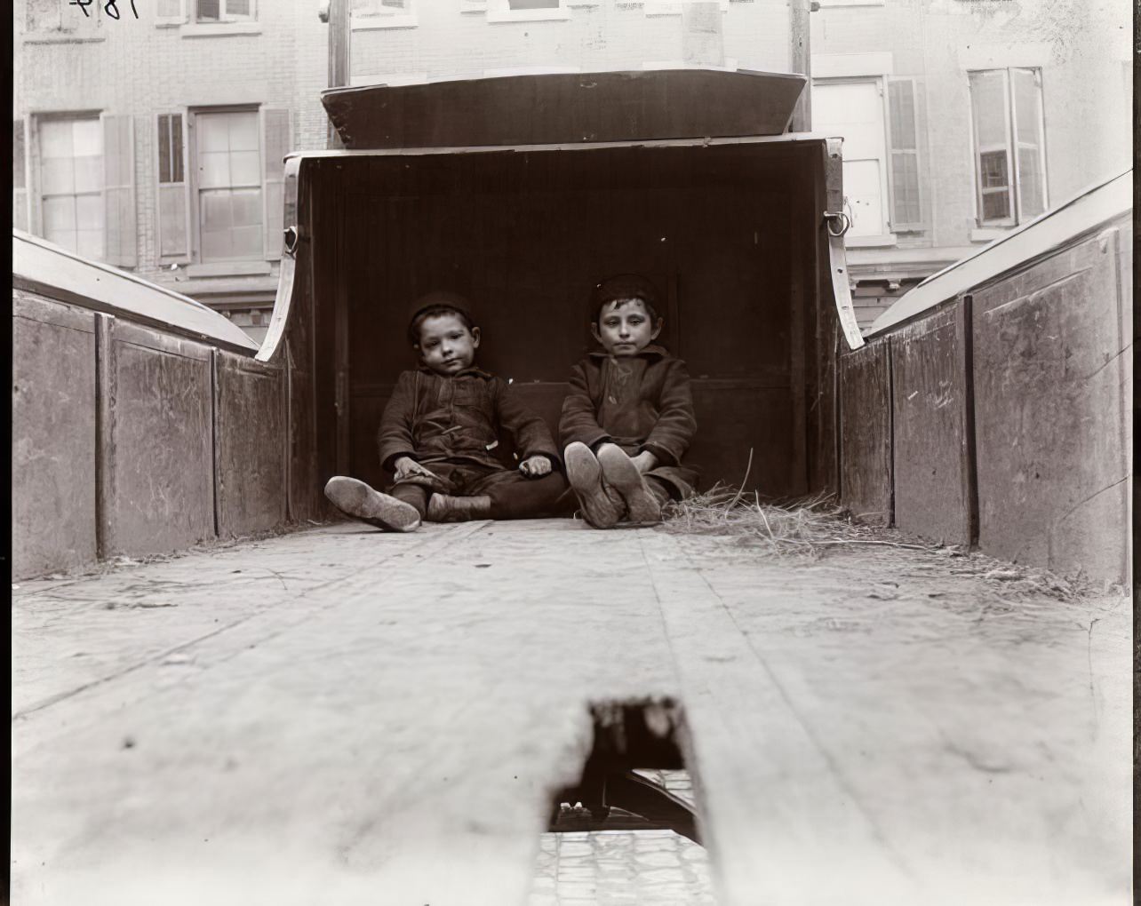Children playing on a truck on Baxter Street, 1890.