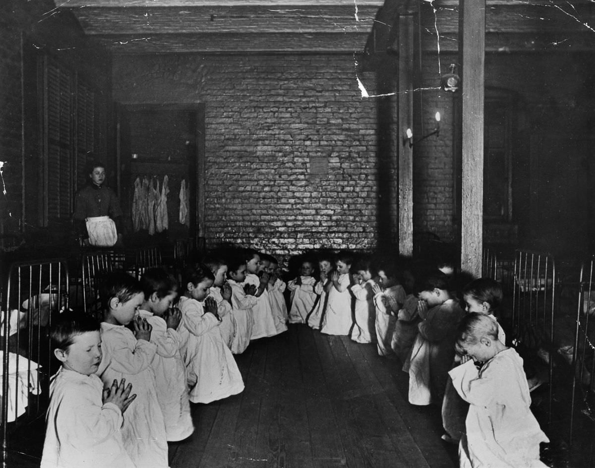 Children pray in the nursery in Five Points House, 1887.