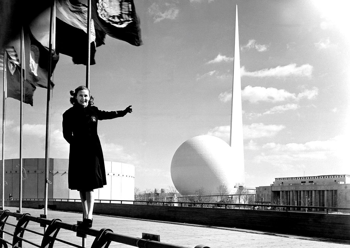 Rosalie Fairbanks, a guide to the New York World's Fair, points to the Trylon and Perisphere, 1939.