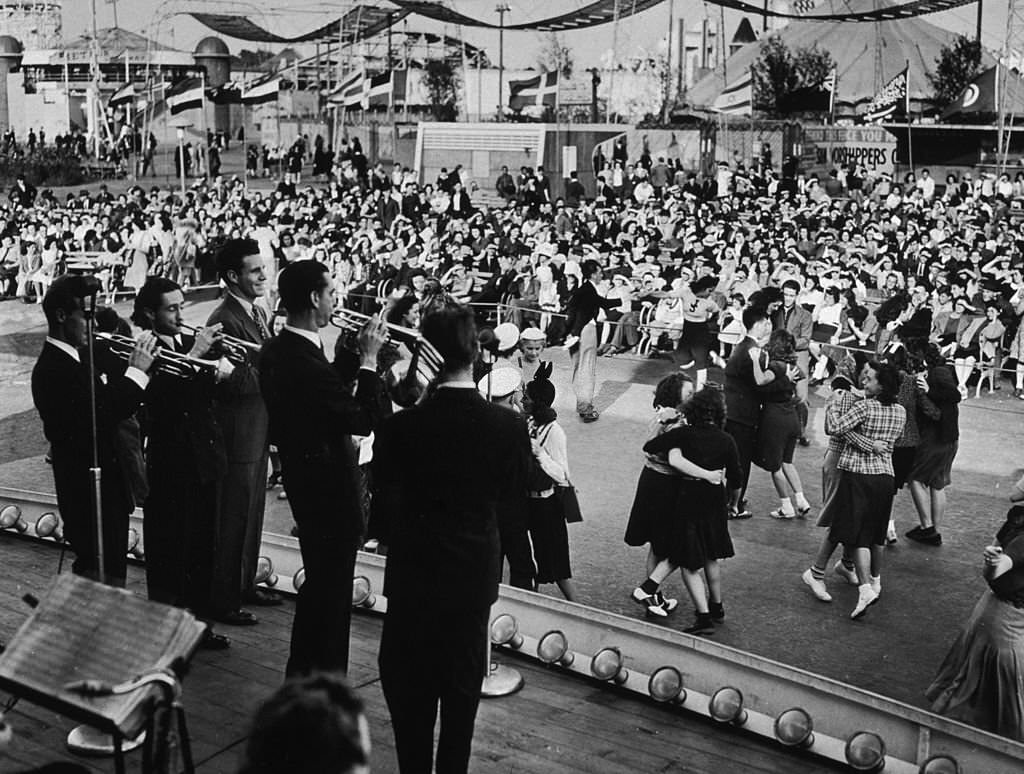 People dance while Ozzie Nelson and his band perform at the amusement area of the 1939 New York World's Fair, 1939.