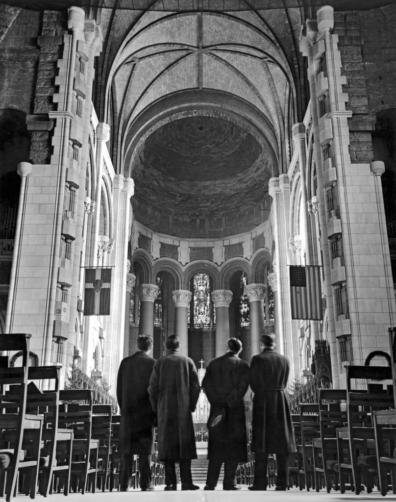 Visitors look toward the unfinished sanctuary and choir at the Cathedral of St John the Divine, New York, 1938.