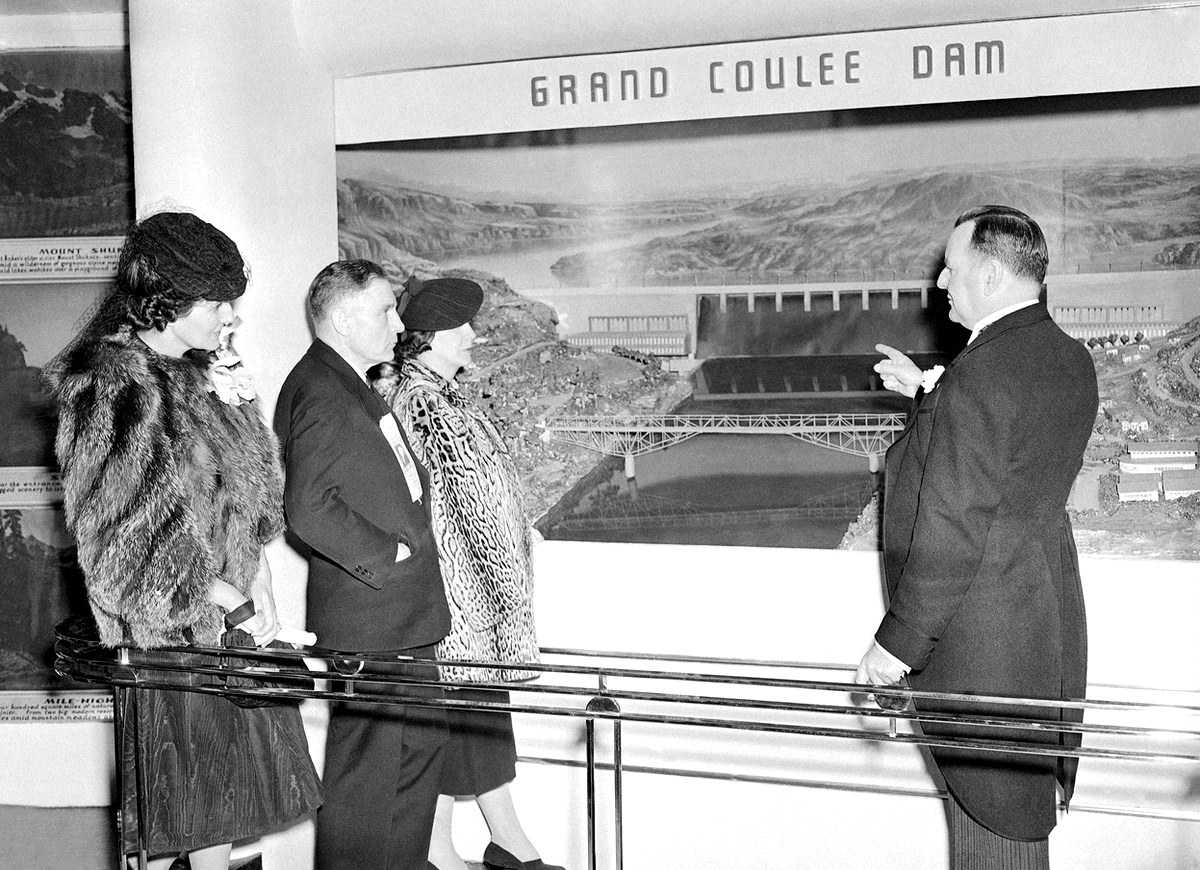 Representatives of the state of Washington look at a diorama of Grand Coulee dam at the New York World's Fair, 1939.