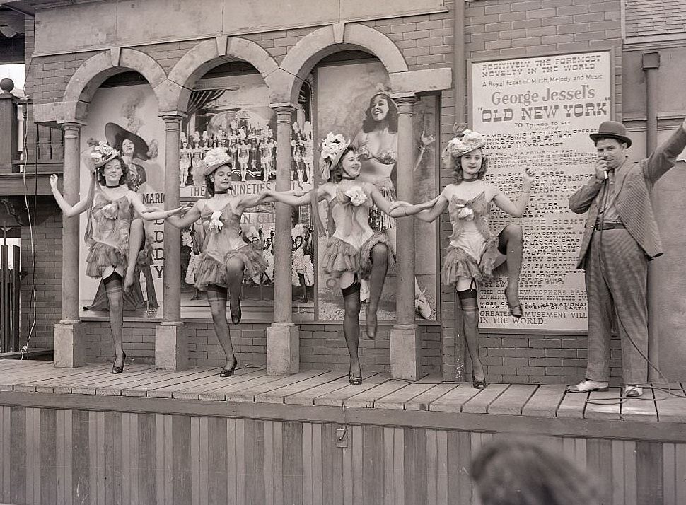 A barker performs with show girls at George Jessel's "old New York" cabaret, at the New York World's Fair, 1939.