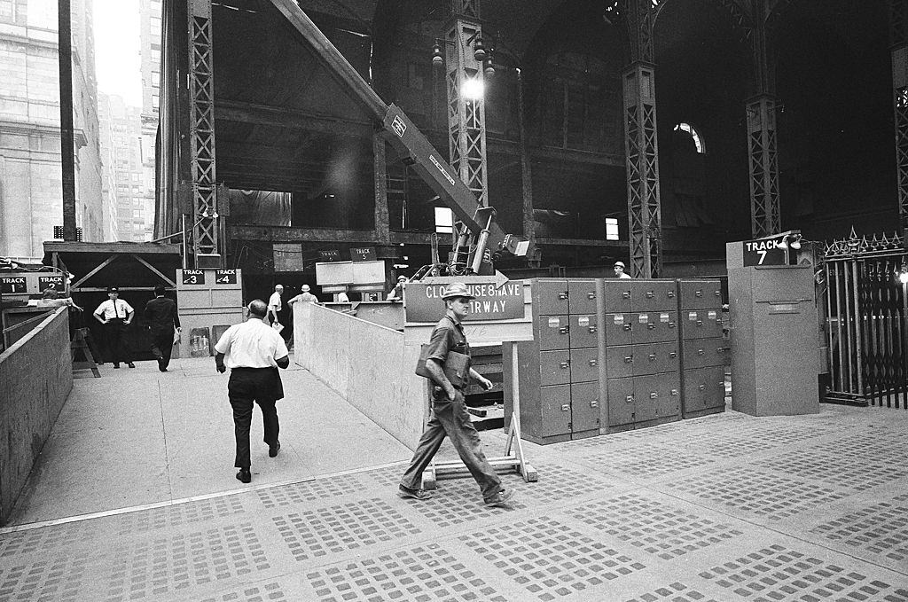 Commuters on their way through a cordoned off-center section of the main floor during the station's demolition, 1965.
