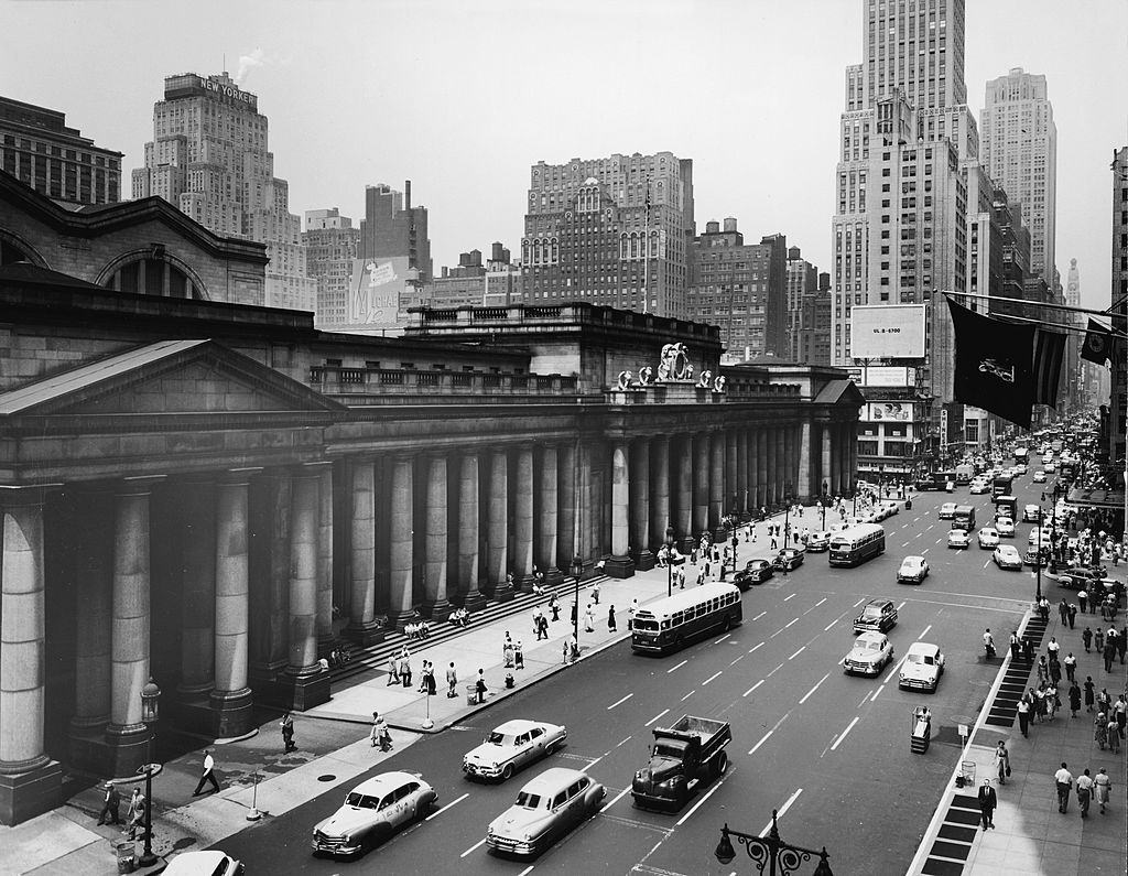 Exterior of Penn Station and traffic along Seventh Avenue, New York, 1950s.