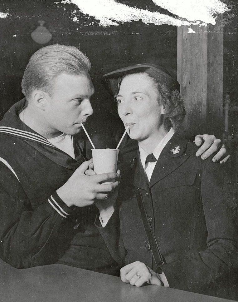 Reunited husband and wife sharing soda at the U.S. Naval Training Station cafeteria, 1944.