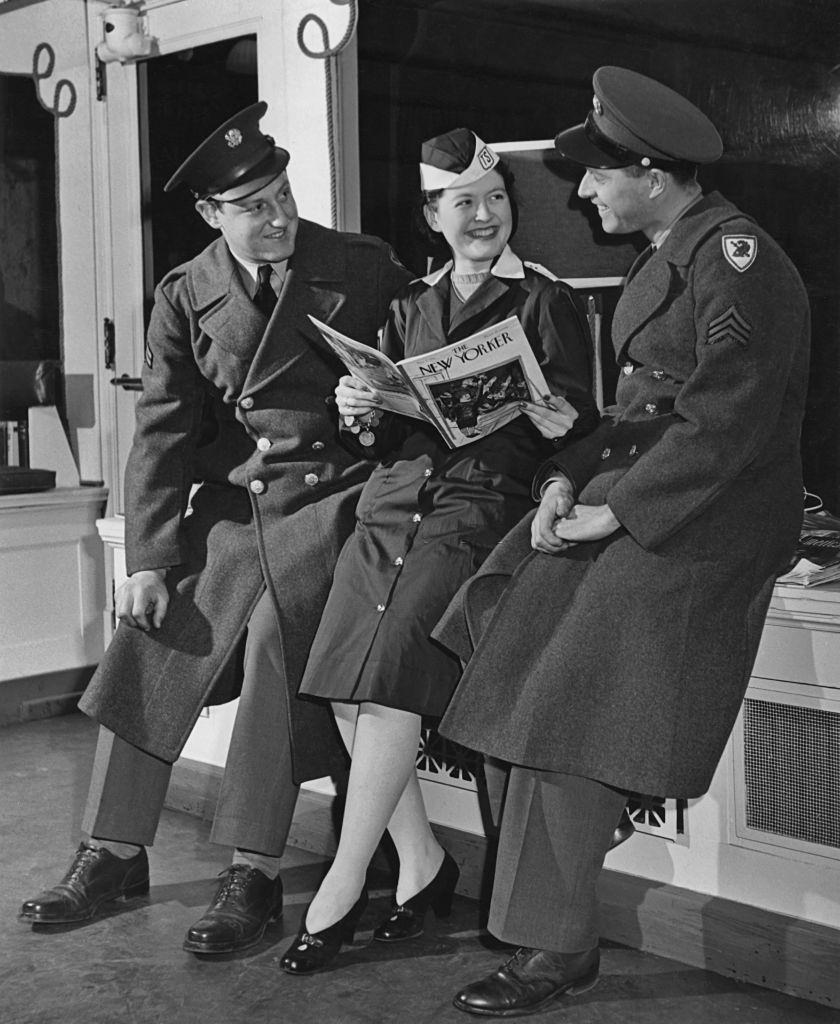 American servicemen with a smiling young woman in the canteen at Pennsylvania Station, New York City, 1943.