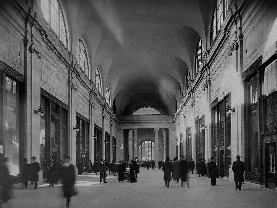 Sunlight cast through the large windows of a vaulted hall in Pennsylvania Station, 1911.