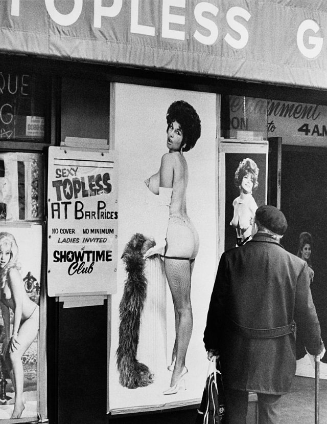 A man walks past the entrance to a topless bar in Times Square, 1975.
