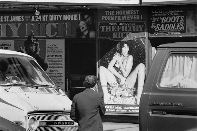 An adult cinema advertises the pornographic film The Filthy Rich, New York City, 1982.