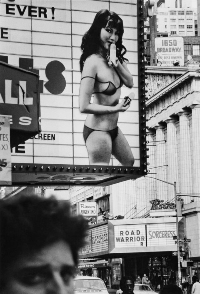 Movie signs on the Rivoli Theatre and neighboring cinemas showcase adult titles, Broadway, New York City, 1983.