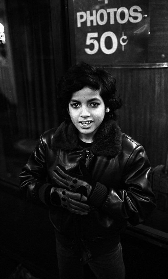 A 12-year-old hustler stands on 7th Avenue near 42nd Street, New York City.