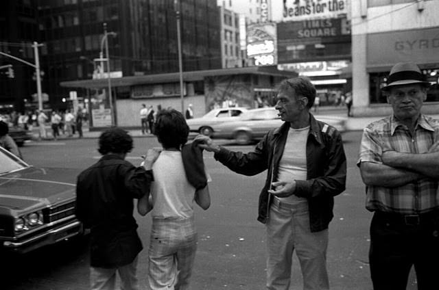 Hustlers gather while chicken hawks wait nearby, a common scene in Times Square’s red-light underworld.