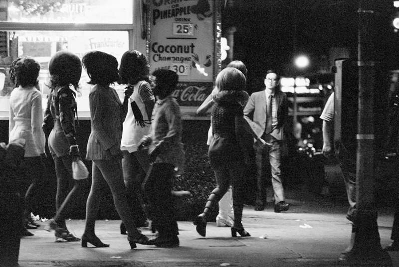 A group of prostitutes walks along the side streets between Broadway and Times Square in the summer of 1971.