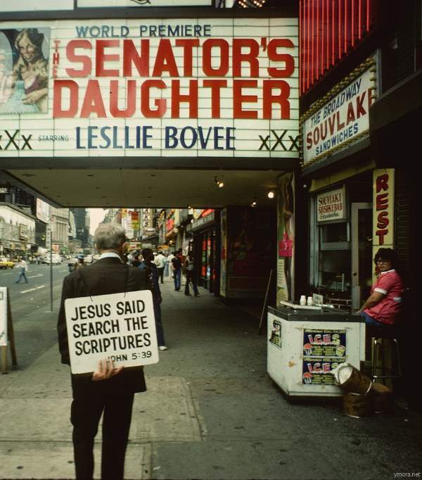 A Christian preacher delivers a sermon outside an adult theater on 8th Avenue, trying to counter the environment around him.