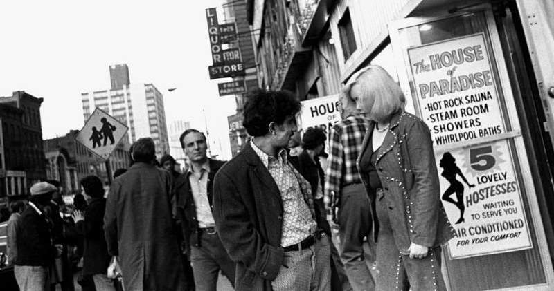 Locals converse in front of the notorious “House of Paradise” adult shop.