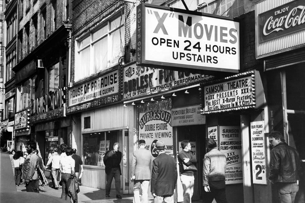 A sex shop offers cinema and live shows, October 1975, typical of the entertainment landscape in Times Square at the time.