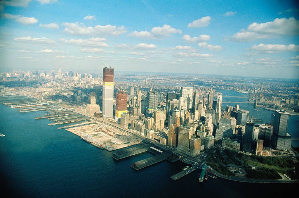 Aerial views of Manhattan featuring the World Trade Center under construction.
