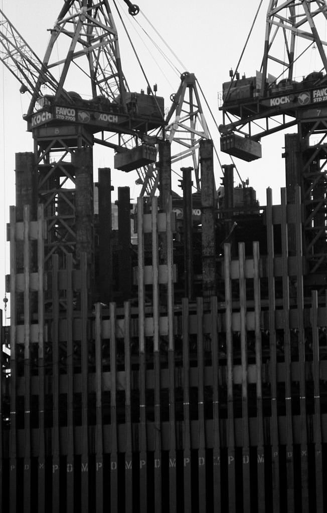 Construction cranes sit on top of a partially constructed Tower One of the World Trade Center, 1970.