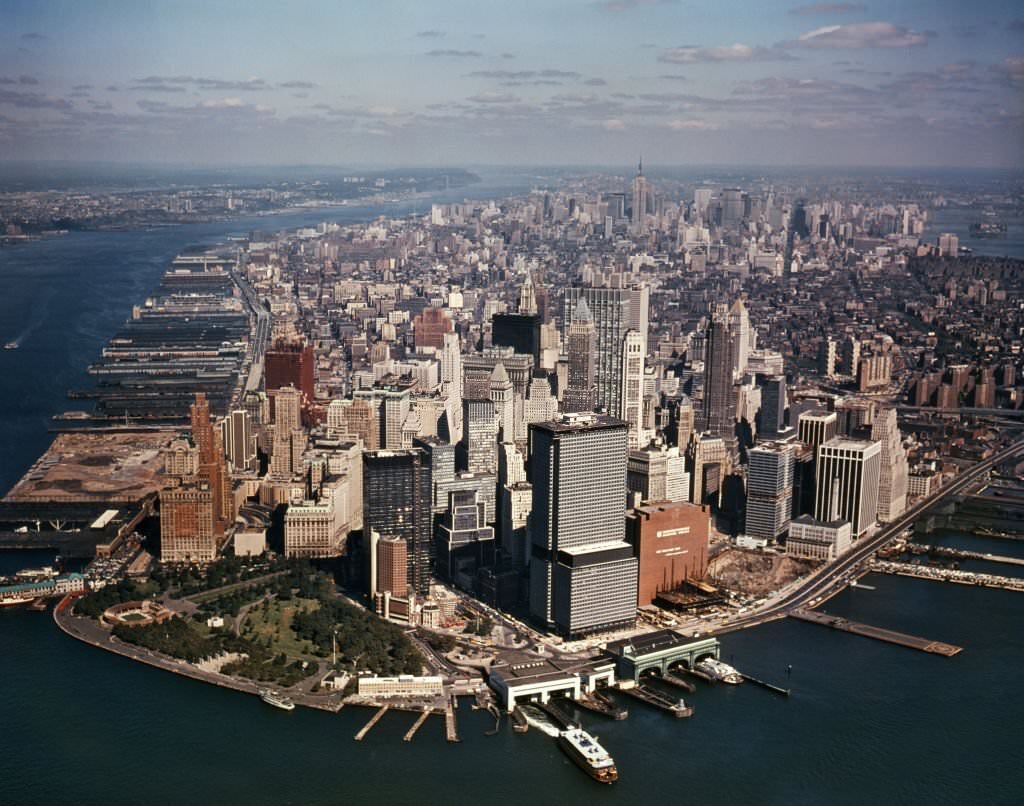 Aerial view of Downtown Manhattan looking North towards Battery Park, World Trade Center under construction, 1970s.