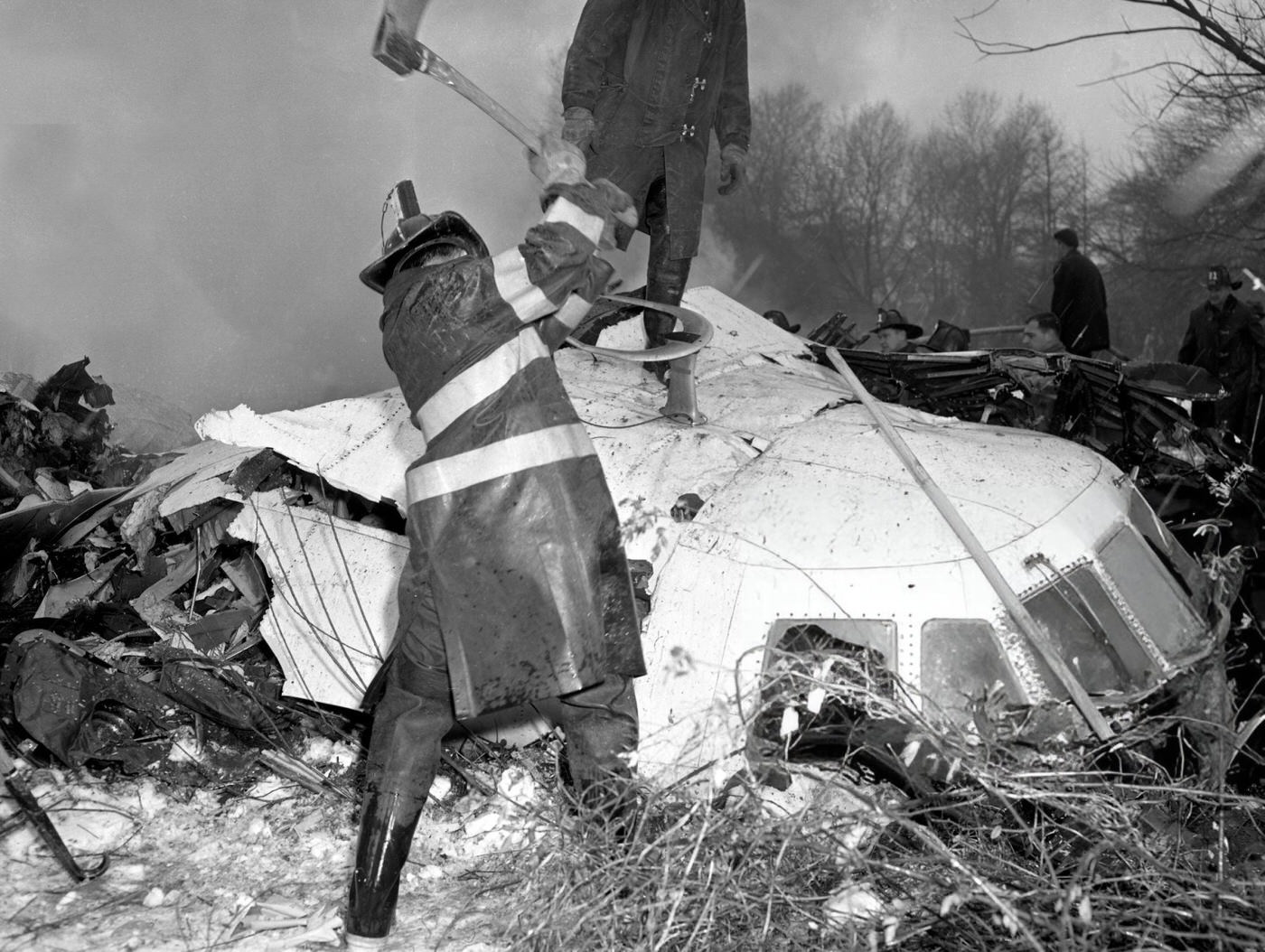 A Fireman Hacks Away At The Cabin Of An Airliner Which Crashed On Staten Island In An Effort To Pull Out The Pilot After The United Airlines Dc-8 &Amp;Amp; Twa Super Constellation Aviation Accident, 1960.