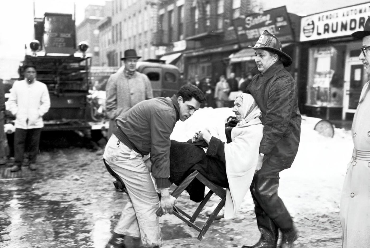 An Elderly Woman Is Carried To Safety At The Site Of The Brooklyn Crash After The United Airlines Dc-8 &Amp;Amp; Twa Super Constellation Aviation Accident, 1960.