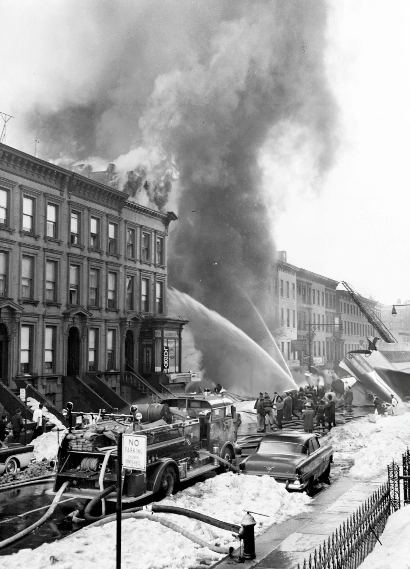 Firemen Play Hoses On A Flaming Building On Seventh Avenue; The Tail Section Of A D-8 Is Visible At Right After The United Airlines Dc-8 &Amp;Amp; Twa Super Constellation Aviation Accident, 1960.