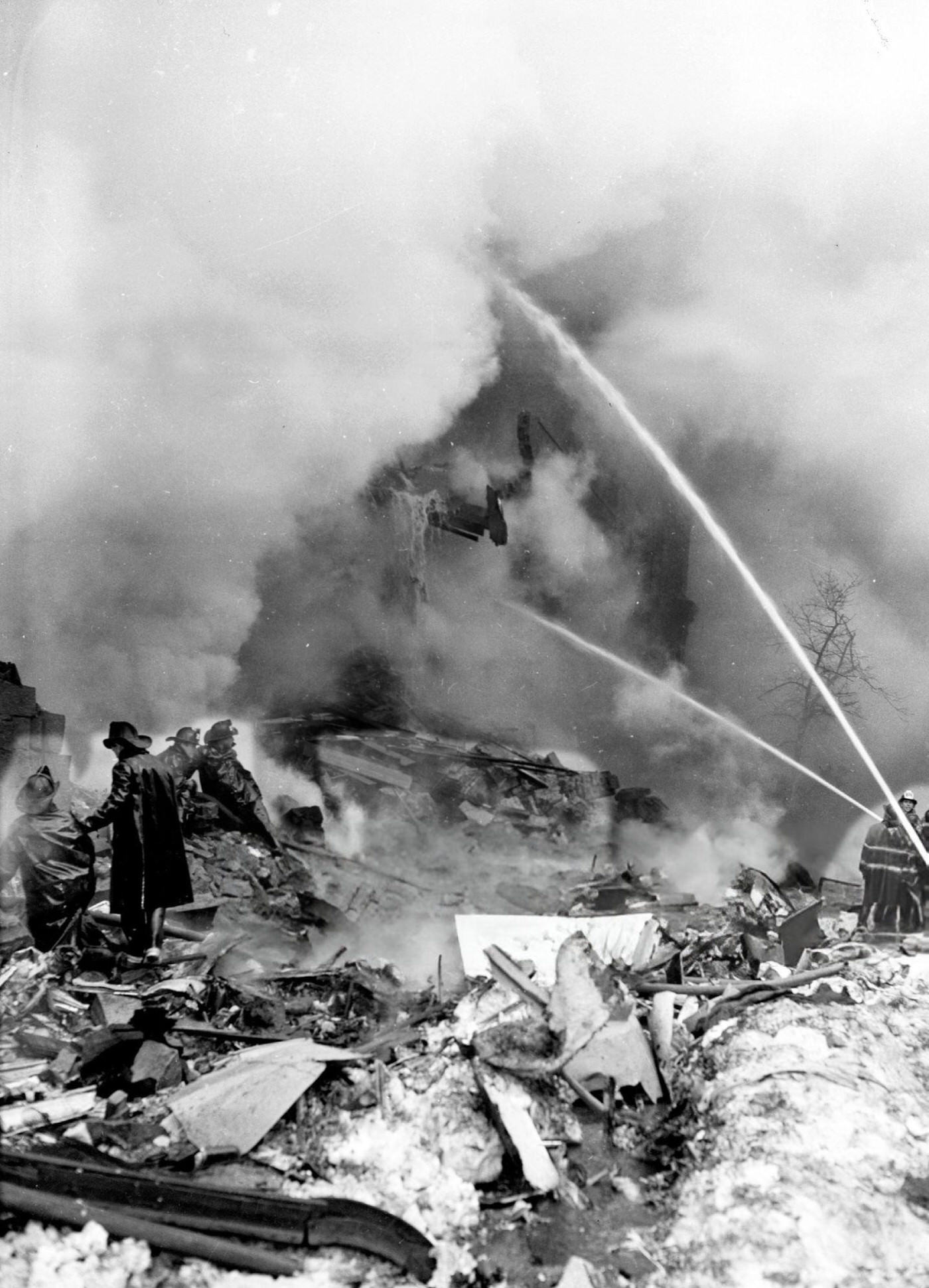 Firemen Stand Amid Rubble, Battling Flames Engulfing A Building Wrecked By The Plane'S Crash On Seventh Avenue And Sterling Place, Brooklyn, After The United Airlines Dc-8 &Amp;Amp; Twa Super Constellation Aviation Accident, 1960.