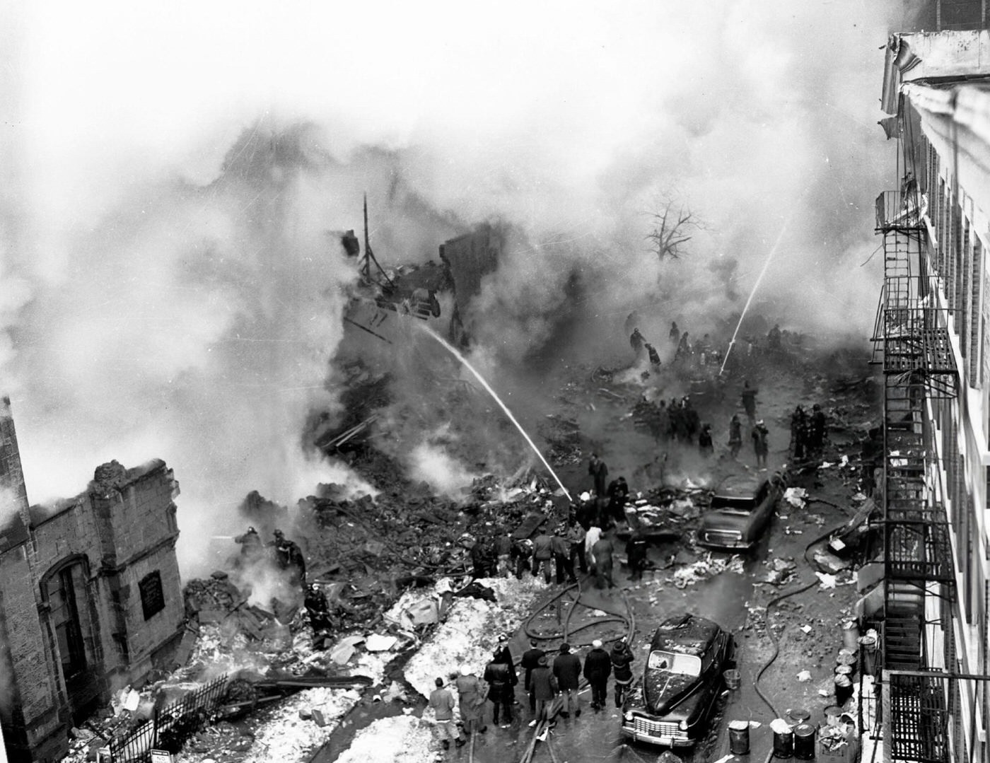 Firemen Pour Water Into The Burning Remains Of An Apartment On Sterling Place After The United Airlines Dc-8 &Amp;Amp; Twa Super Constellation Aviation Accident, 1960.